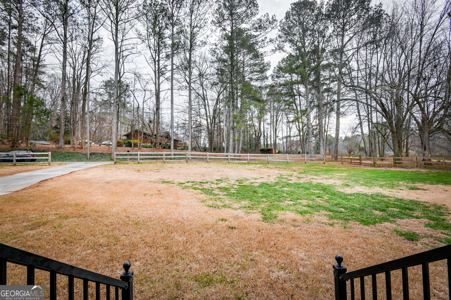 93 Deerfield Road Covington, GA 30014 - Photo 6 of 78 a backyard of a house with lots of green space and trees