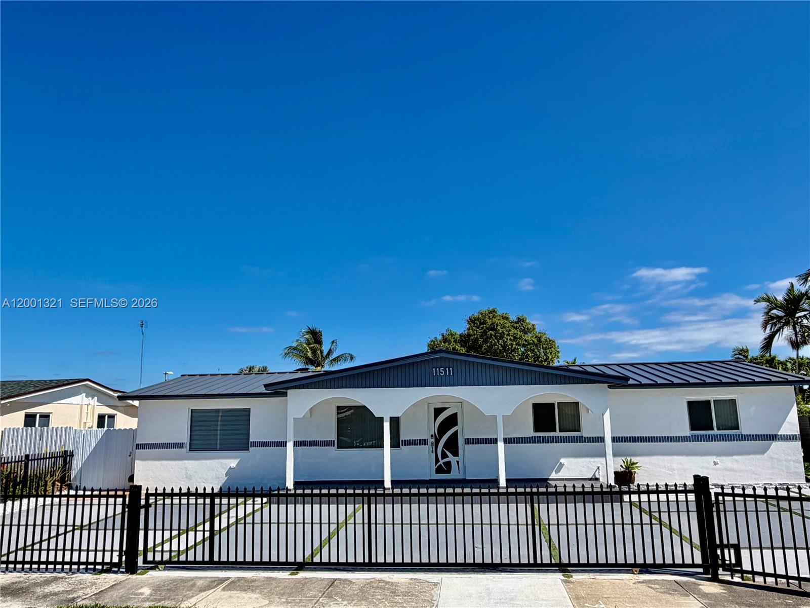 11511 Southwest 180th Street Miami, FL 33157 - Photo 1 of 22 a view of a house with a small yard