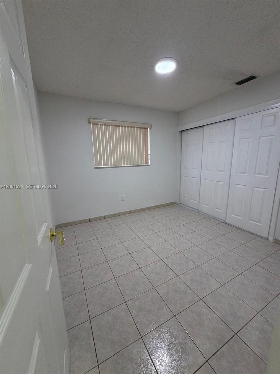 11511 Southwest 180th Street Miami, FL 33157 - Photo 14 of 22 a view of an empty room with a window