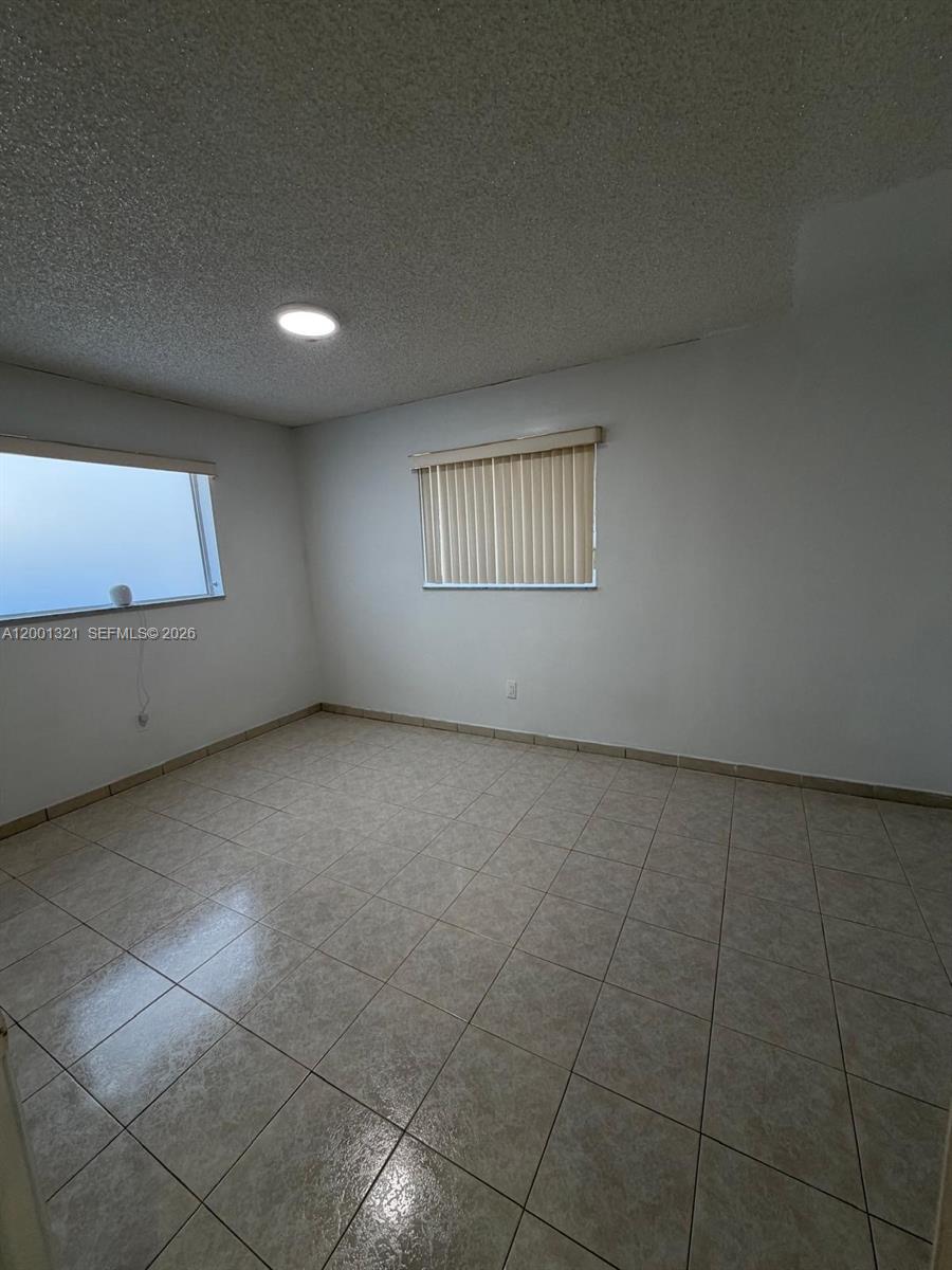 11511 Southwest 180th Street Miami, FL 33157 - Photo 15 of 22 a view of an empty room with a window