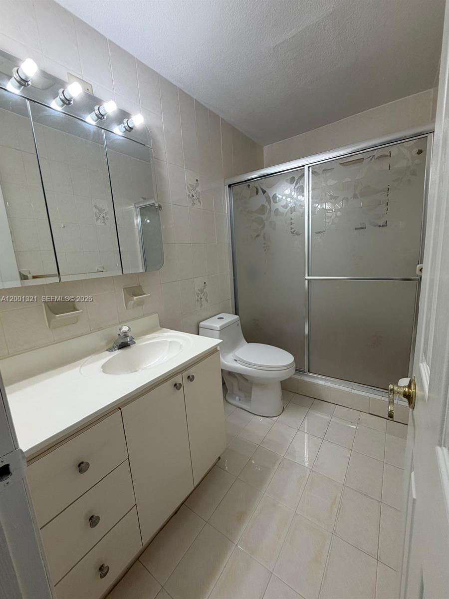 11511 Southwest 180th Street Miami, FL 33157 - Photo 17 of 22 a bathroom with a double vanity sink toilet and a mirror