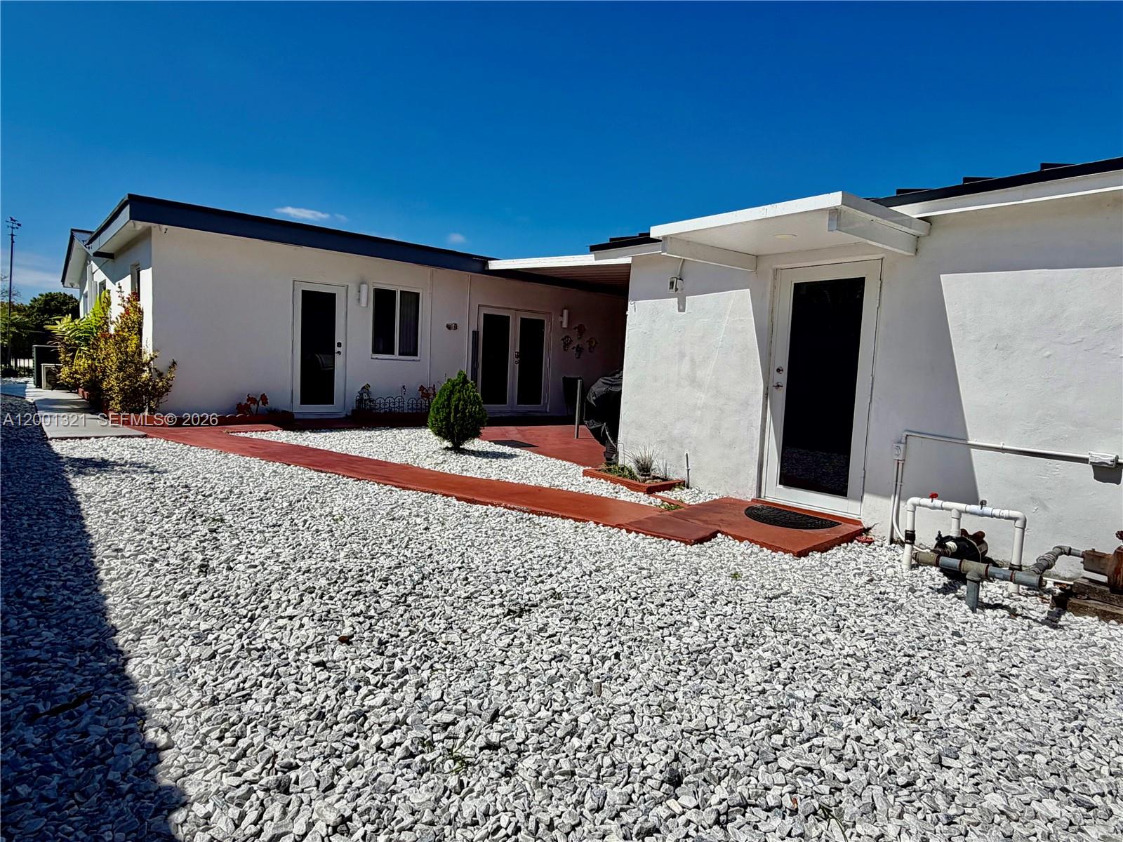 11511 Southwest 180th Street Miami, FL 33157 - Photo 3 of 22 a front view of a house with a patio