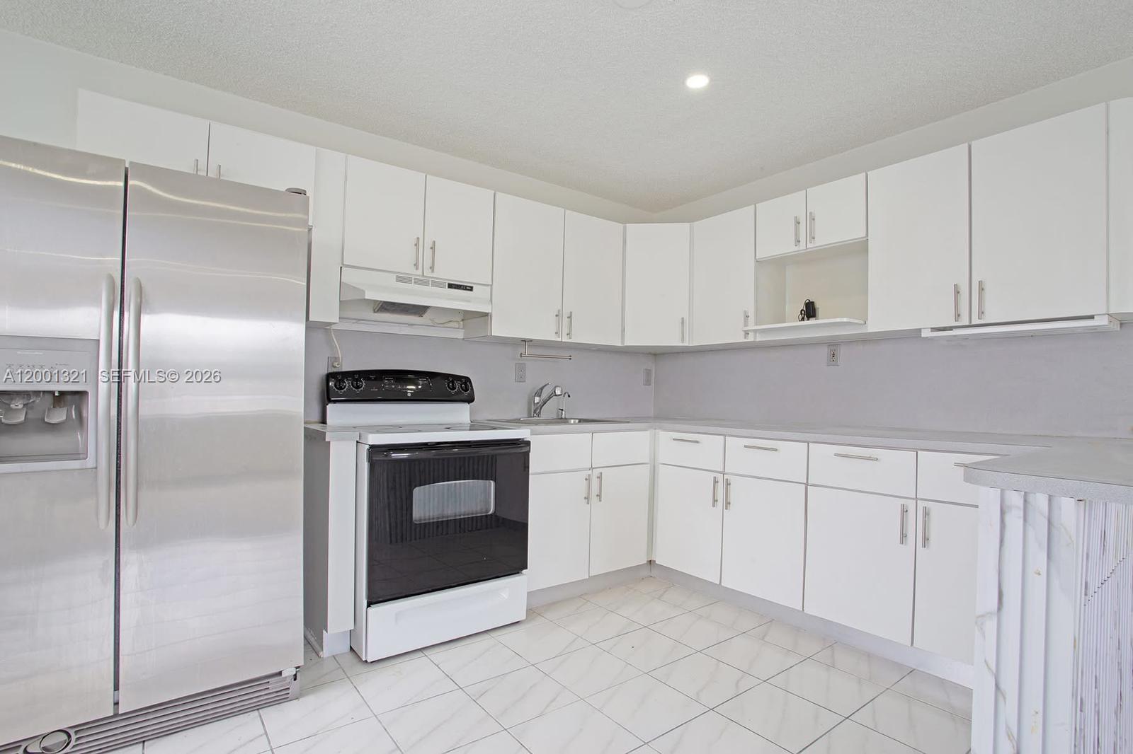 11511 Southwest 180th Street Miami, FL 33157 - Photo 6 of 22 a kitchen with cabinets stainless steel appliances and a sink