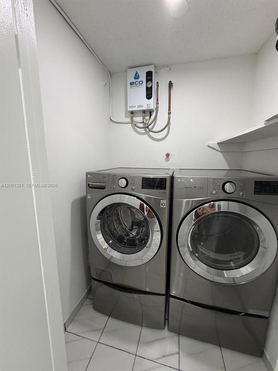11511 Southwest 180th Street Miami, FL 33157 - Photo 9 of 22 a view of a storage & utility room with washer and dryer