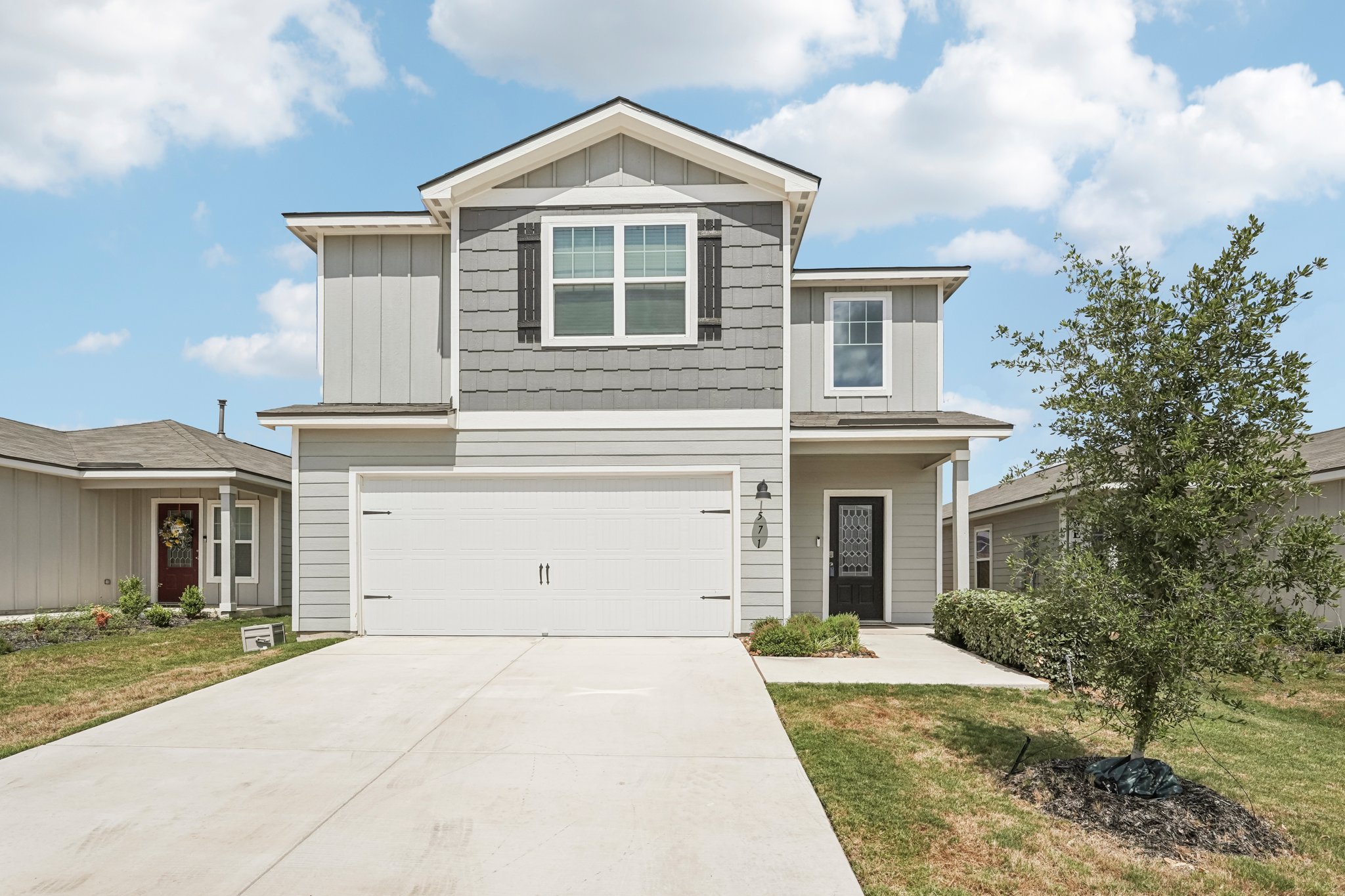 a front view of a house with a yard and garage