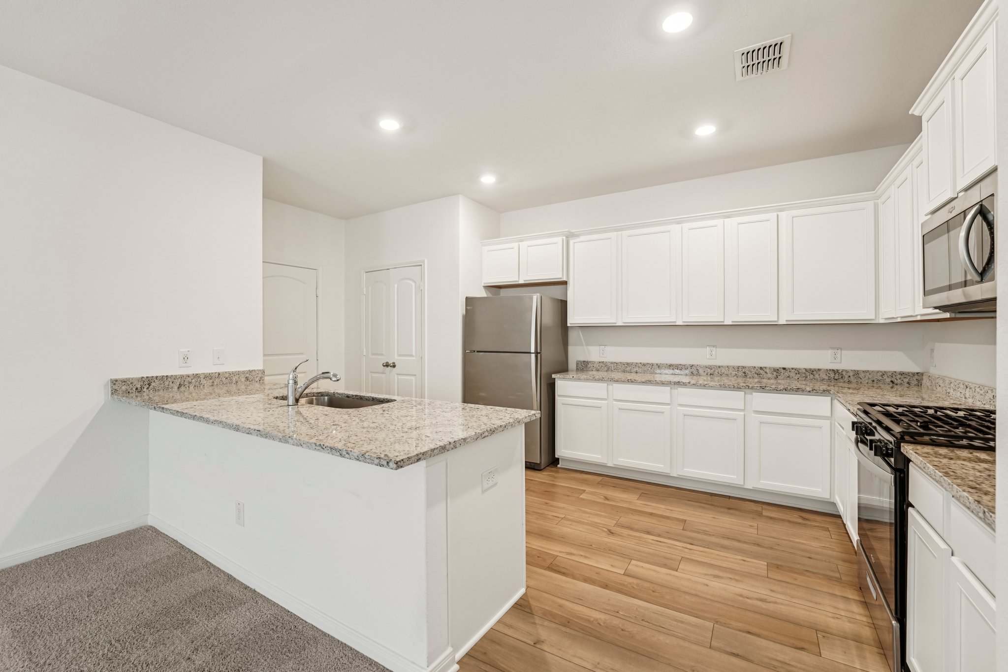 571 Aplite Pass Maxwell, TX 78656 - Photo 15 of 28 a kitchen with stainless steel appliances granite countertop a sink stove and refrigerator