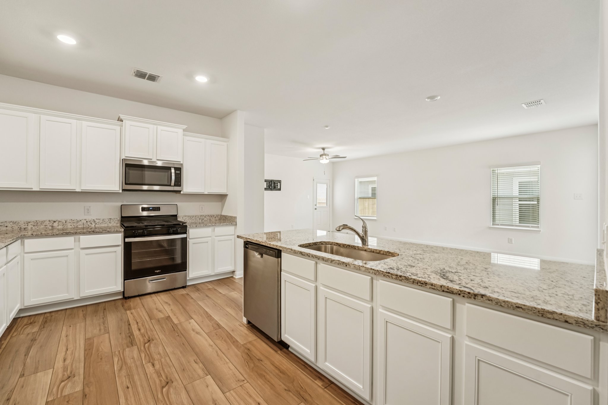 571 Aplite Pass Maxwell, TX 78656 - Photo 16 of 28 a kitchen with granite countertop stainless steel appliances a stove sink and microwave