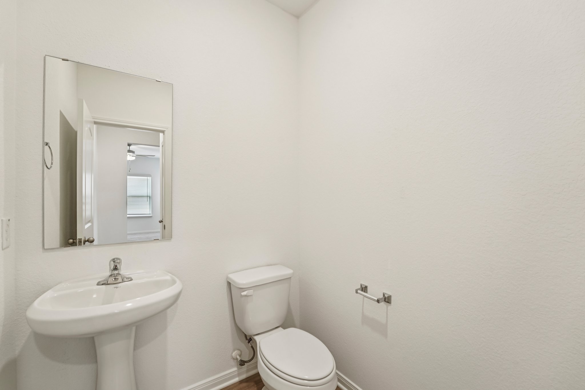 571 Aplite Pass Maxwell, TX 78656 - Photo 17 of 28 a bathroom with a toilet sink and mirror
