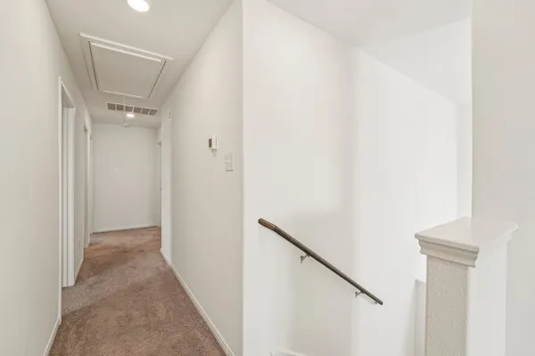 a view of a hallway with a white walls
