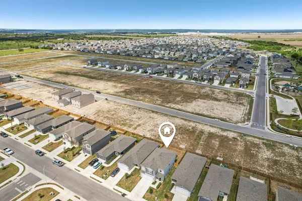 an aerial view of residential houses with outdoor space