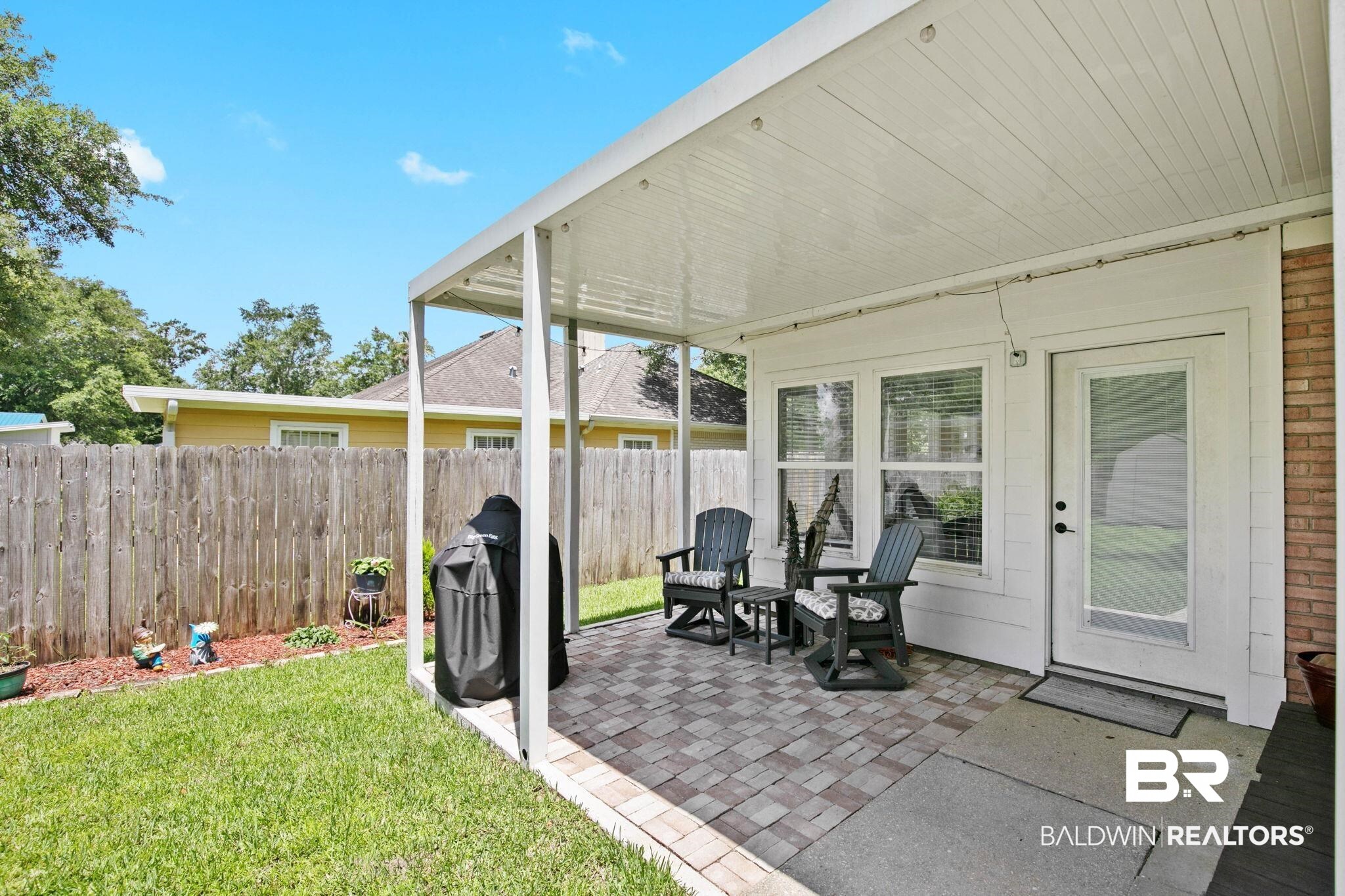520 Juniper Place Drive Foley, AL 36535 - Photo 27 of 35 Covered patio featuring paver flooring, a white paneled ceiling, and direct access to the interior through a glass-paneled door