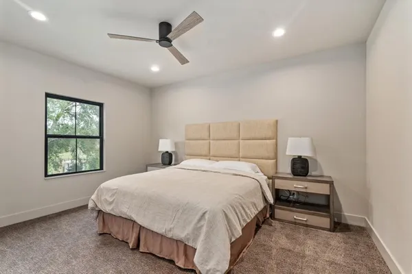 a bedroom with a bed and a window