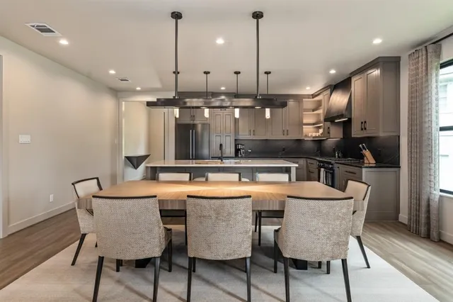 a kitchen with stainless steel appliances granite countertop a kitchen island a stove and a wooden cabinets