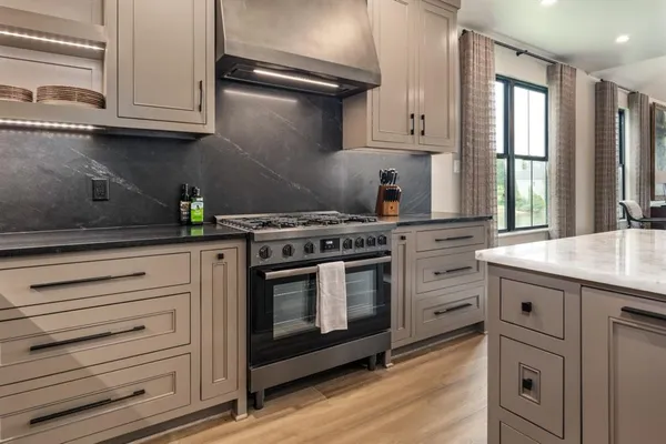 a kitchen with granite countertop white cabinets and appliances