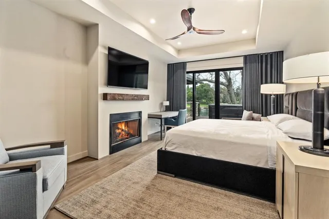 a bed room with a bed tv and a fireplace