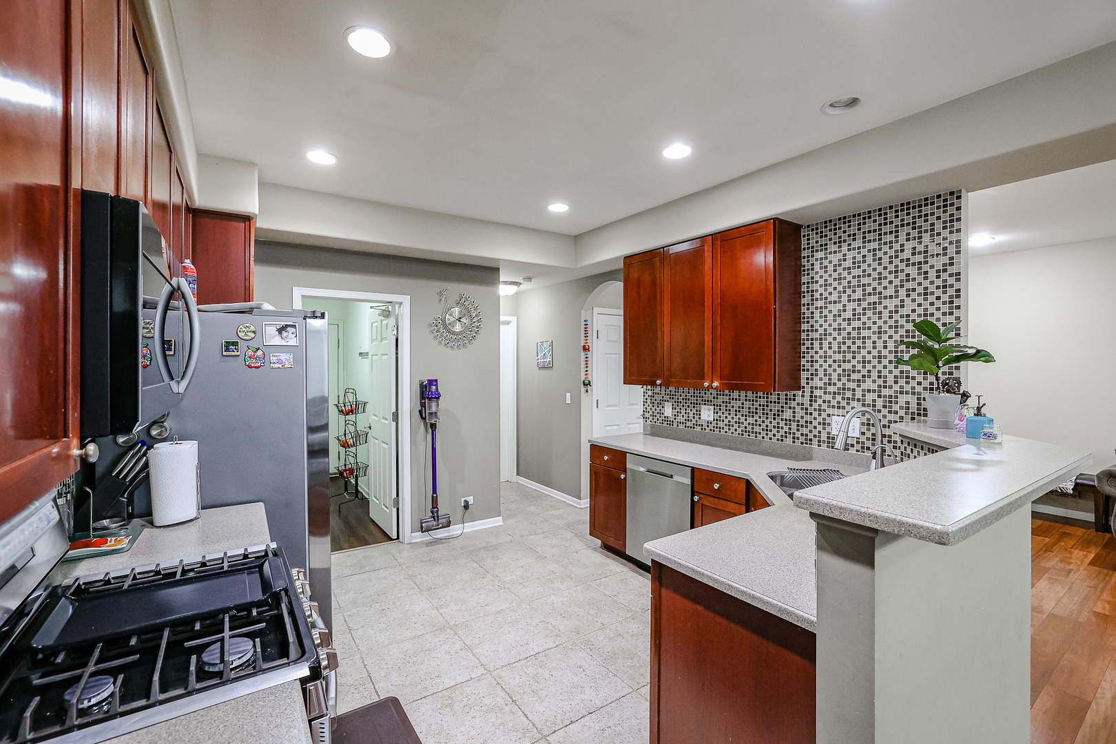 1322 Tamarack Drive Bartlett, IL 60103 - Photo 13 of 30 a kitchen with stainless steel appliances kitchen island granite countertop a stove and a refrigerator