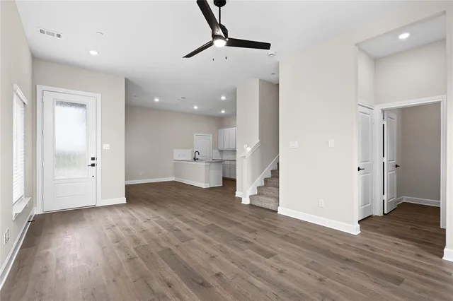 a view of a kitchen with wooden floor and a sink