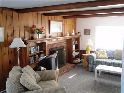8 Sumac Road West Dennis, MA 02670 - Photo 10 of 23 a living room with furniture a large window and a fireplace