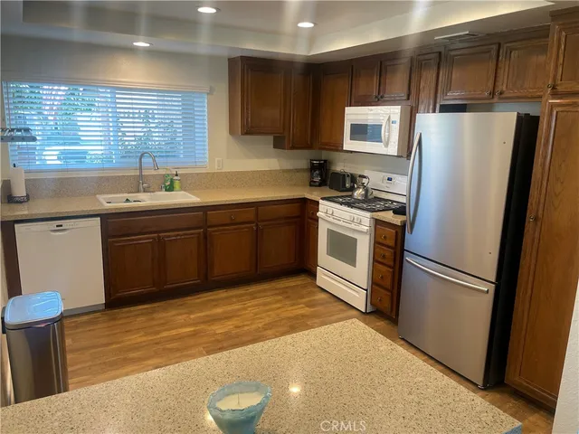 a kitchen with stainless steel appliances granite countertop a refrigerator sink and stove