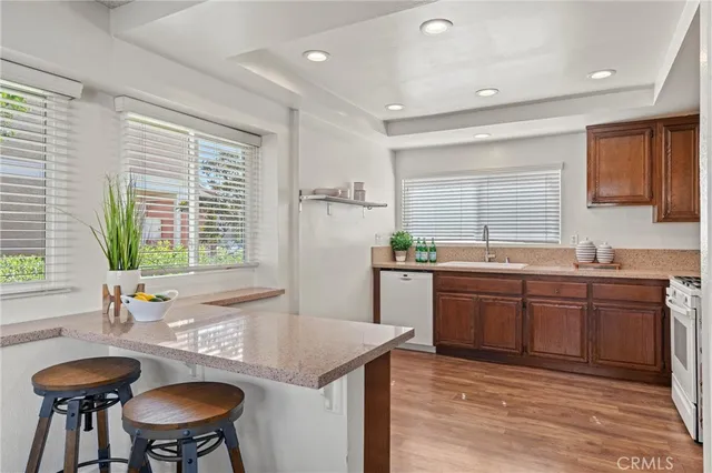 a kitchen with granite countertop a sink and a refrigerator