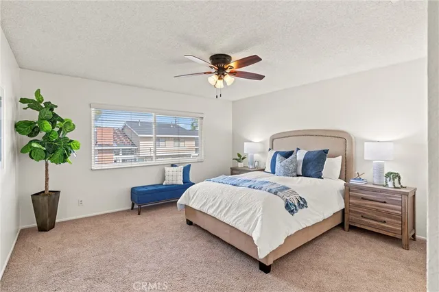 a bedroom with a bed potted plant and a window