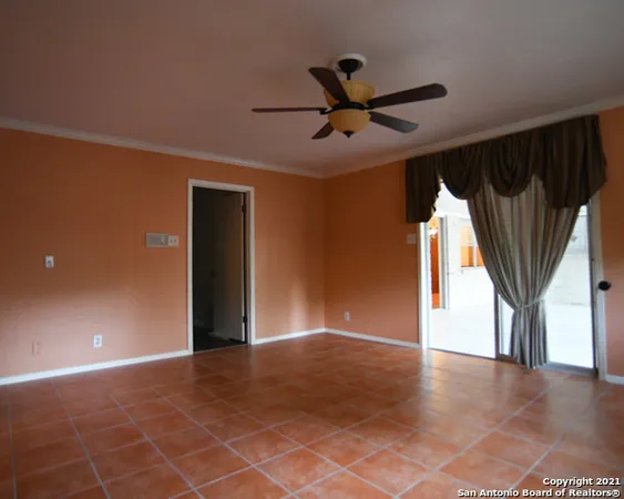 a view of a livingroom with a ceiling fan and window