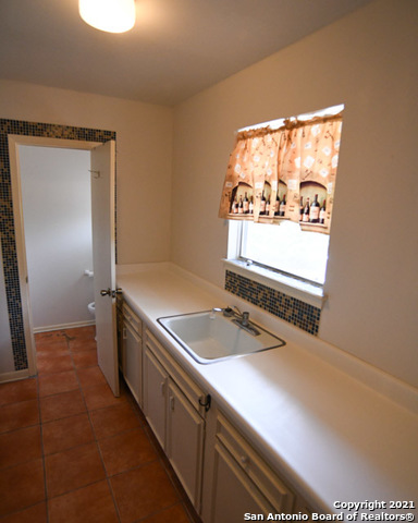 6207 Shady Brook Windcrest, TX 78239 - Photo 18 of 23 a bathroom with a sink and a mirror