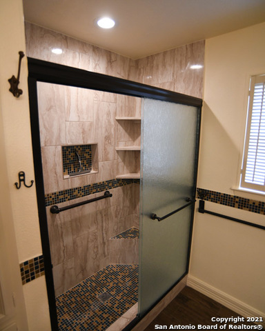 6207 Shady Brook Windcrest, TX 78239 - Photo 22 of 23 a bathroom with a shower and a mirror