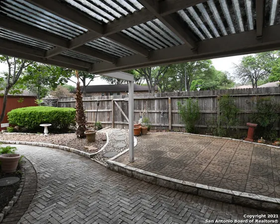 a view of a backyard with sitting area