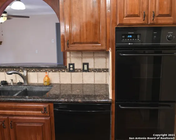 a kitchen with granite countertop stainless steel appliances and cabinets