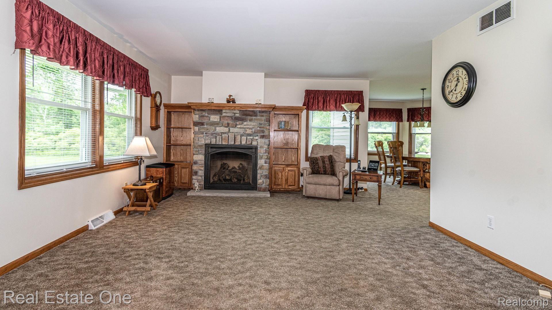 6351 Klam Road Otter Lake, MI 48464 - Photo 6 of 26 Gas Fireplace with stone surround and built in bookcases