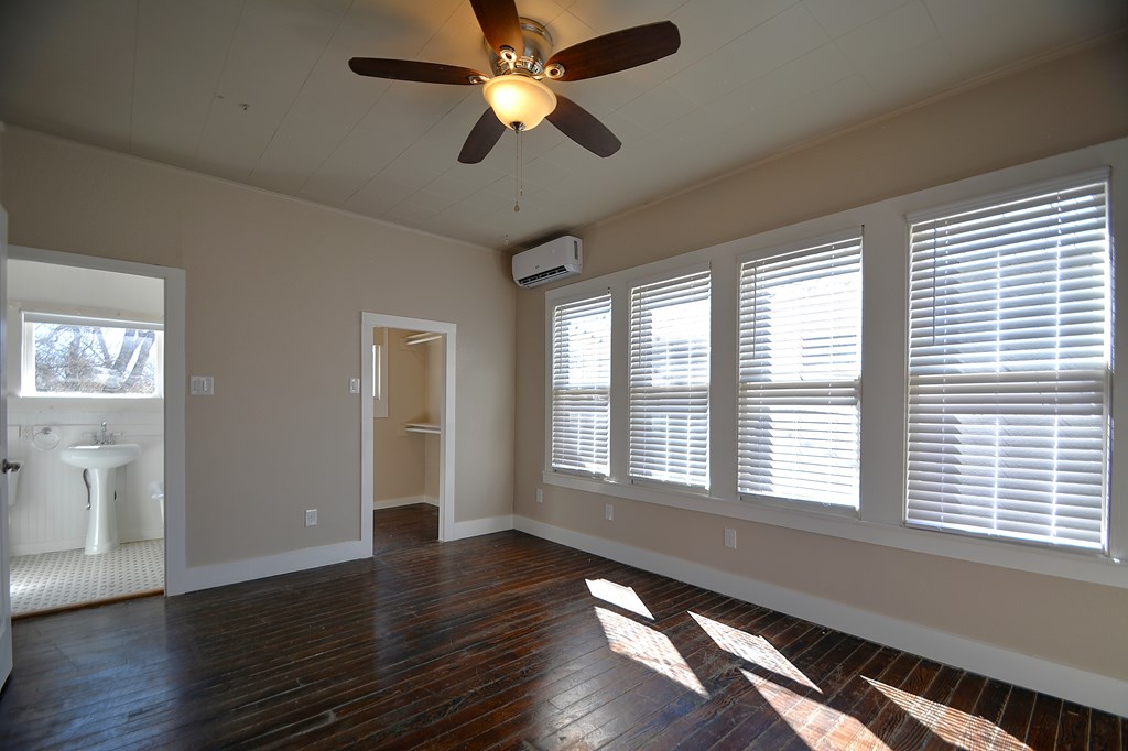 309 Lowry Street Kerrville, TX 78028 - Photo 12 of 29 a view of an empty room with wooden floor and a window