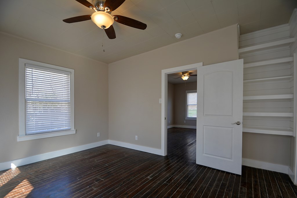 309 Lowry Street Kerrville, TX 78028 - Photo 15 of 29 a view of an empty room with wooden floor and a window