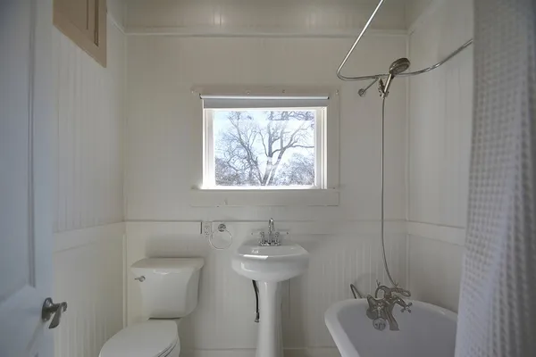 a bathroom with a sink mirror and toilet
