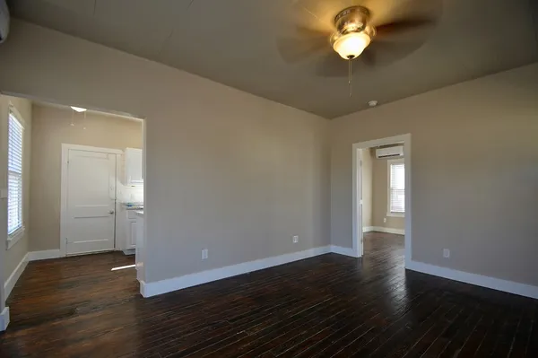 a view of empty room with wooden floor