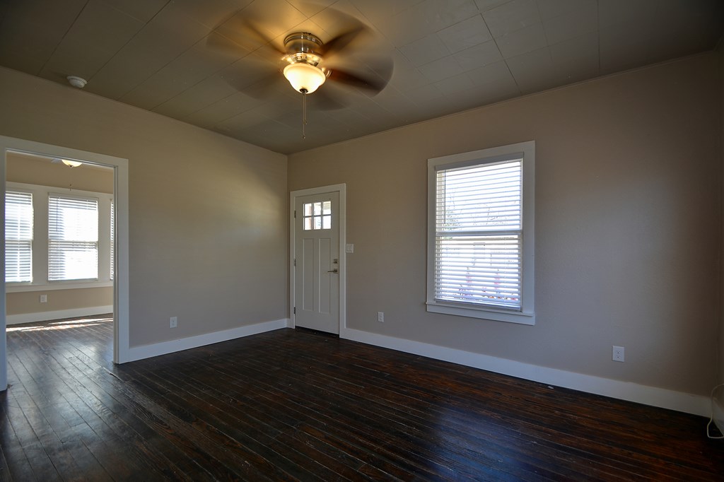 309 Lowry Street Kerrville, TX 78028 - Photo 6 of 29 a view of empty room with wooden floor and fan