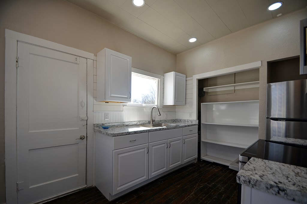 309 Lowry Street Kerrville, TX 78028 - Photo 7 of 29 a kitchen with a sink appliances and cabinets