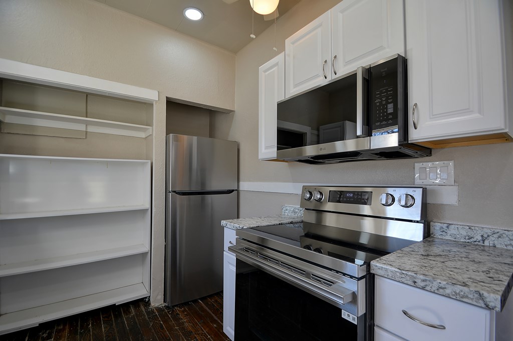 309 Lowry Street Kerrville, TX 78028 - Photo 8 of 29 a kitchen with a stove microwave and refrigerator