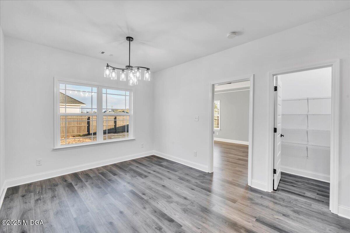 103 Early Drive Byron, GA 31008 - Photo 12 of 44 an empty room with wooden floor cabinet and windows