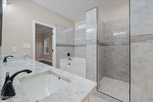 a bathroom with a tub sink and mirror