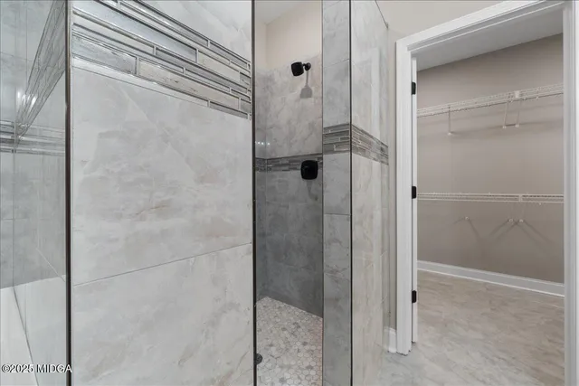 a bathroom with a glass shower door