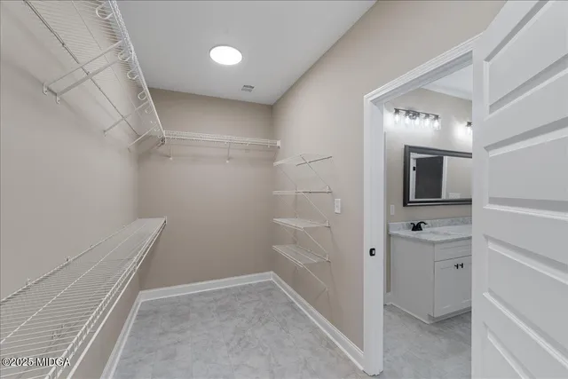 a view of bathroom with a sink and mirror