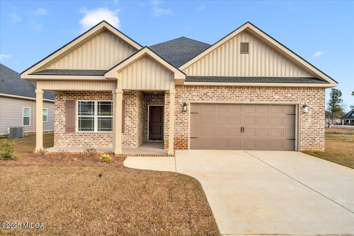 103 Early Drive Byron, GA 31008 - Photo 2 of 44 a front view of a house with a yard and garage