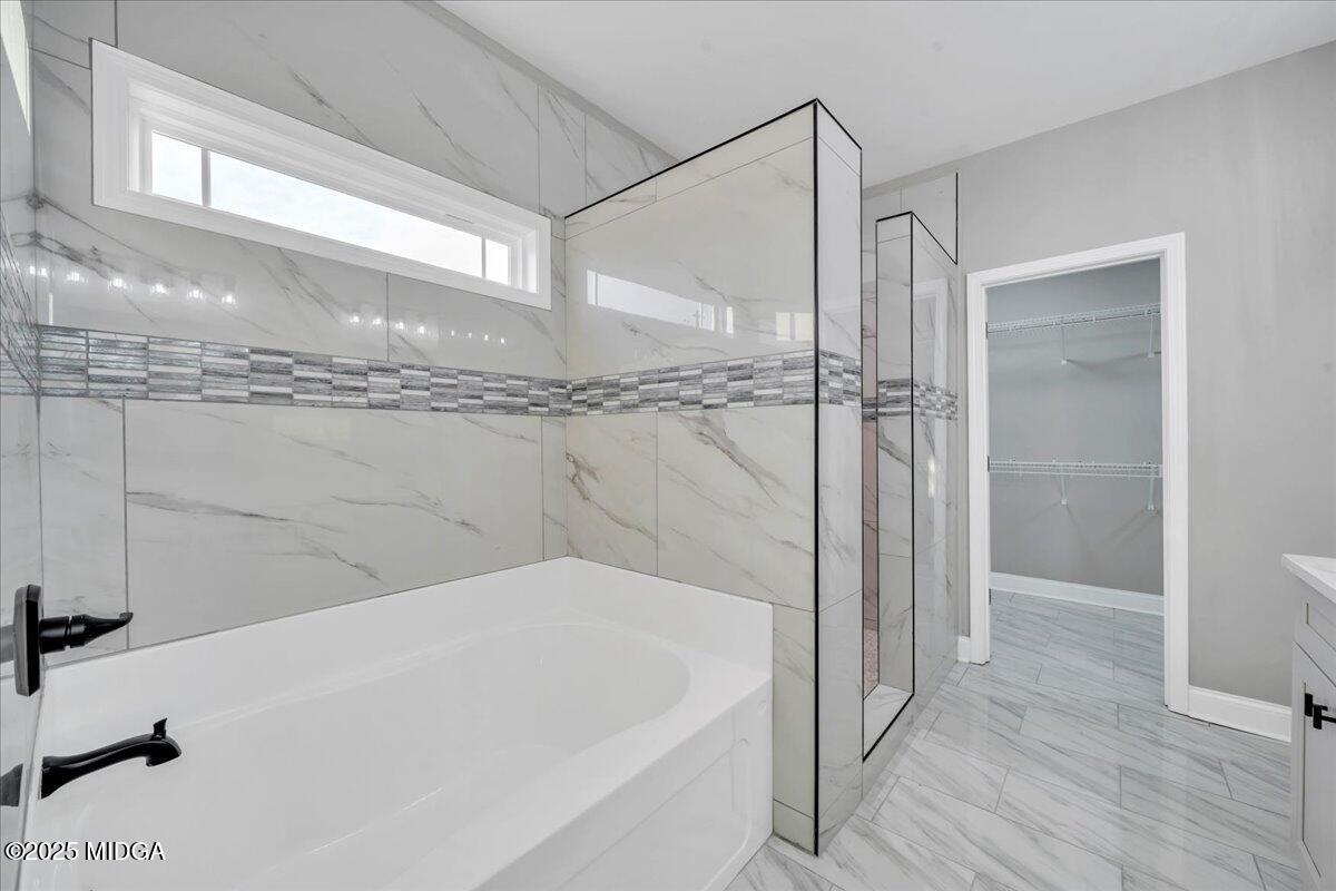 103 Early Drive Byron, GA 31008 - Photo 25 of 44 a bathroom with a bathtub and a shower