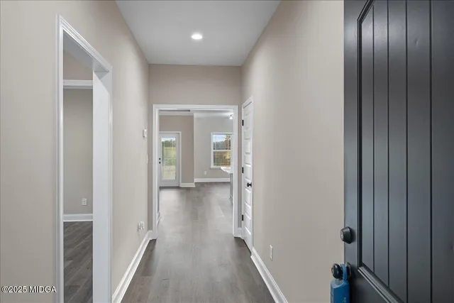 a view of a hallway with wooden floor