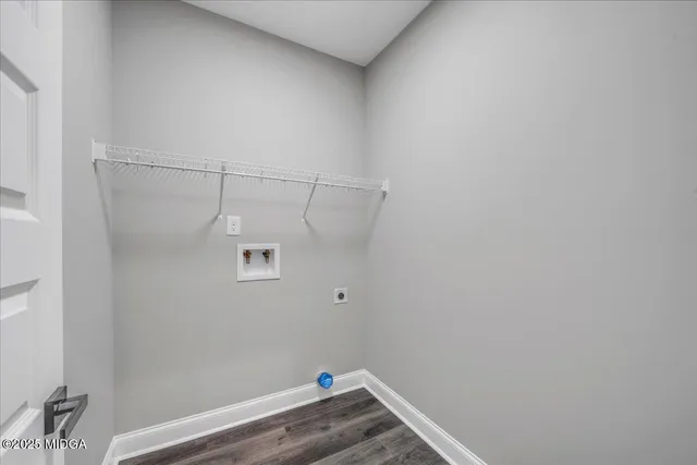 a view of a room with wooden floor and a window