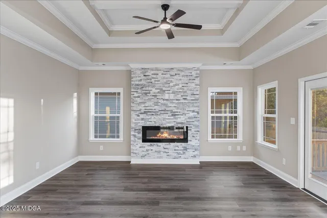 a living room with a fireplace and wooden floor