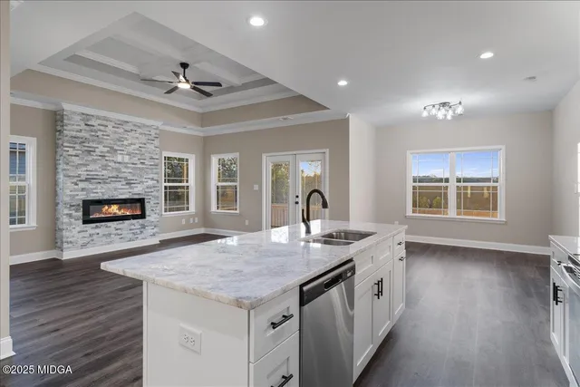 a open kitchen with a sink and a fireplace