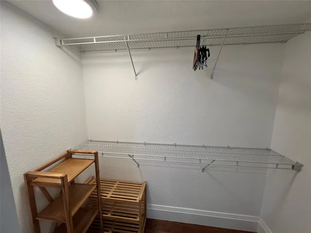a view of storage and utility room with racks on the wall