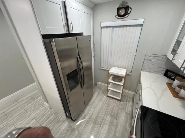 a view of a kitchen with appliances and cabinets